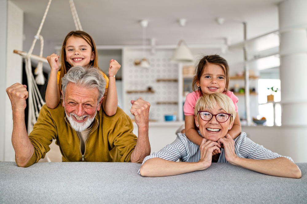 Grandchildren and grandparents having fun together in their kitchen
